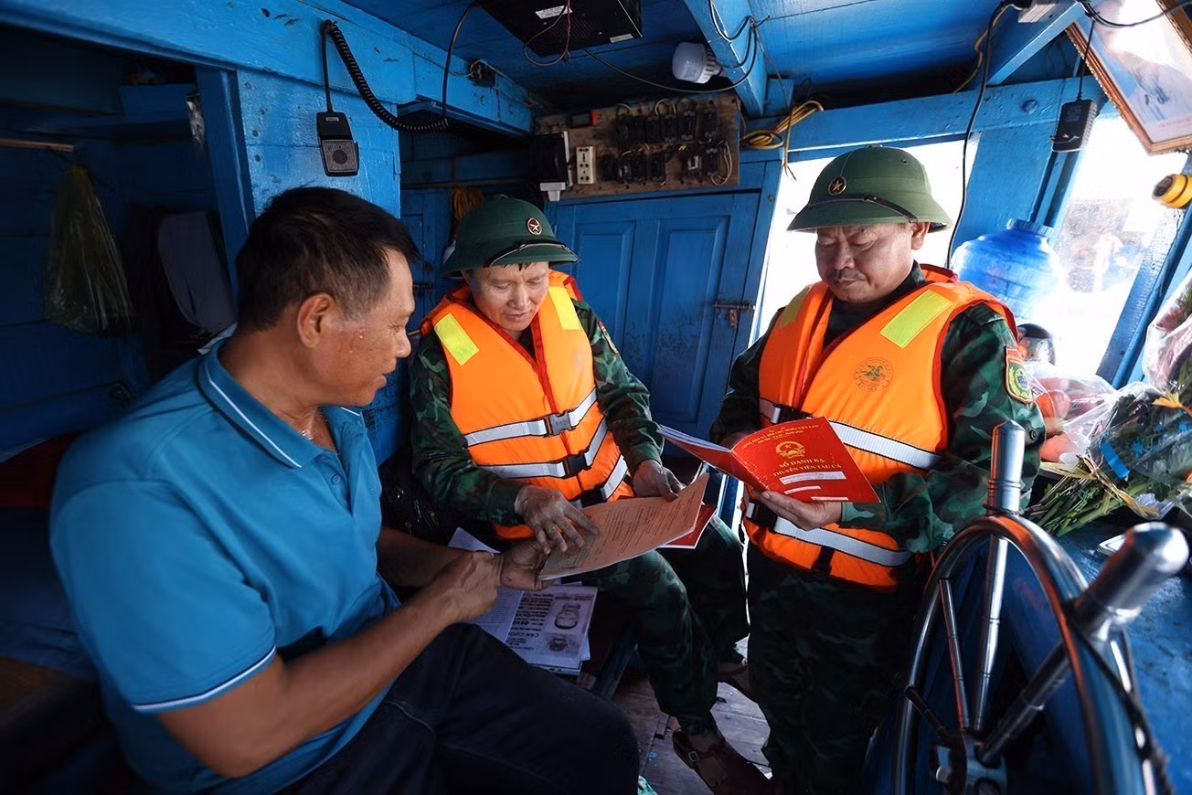 Bộ đội Biên phòng Hải Hoà kiểm tra thủ tục hành chính đối với chủ tàu cá Nguyễn Văn Chiến, chuẩn bị ra khơi khai thác thuỷ sản, tại cảng cá Lạch Bạng, phường Hải Bình, tỉnh Thanh Hóa.