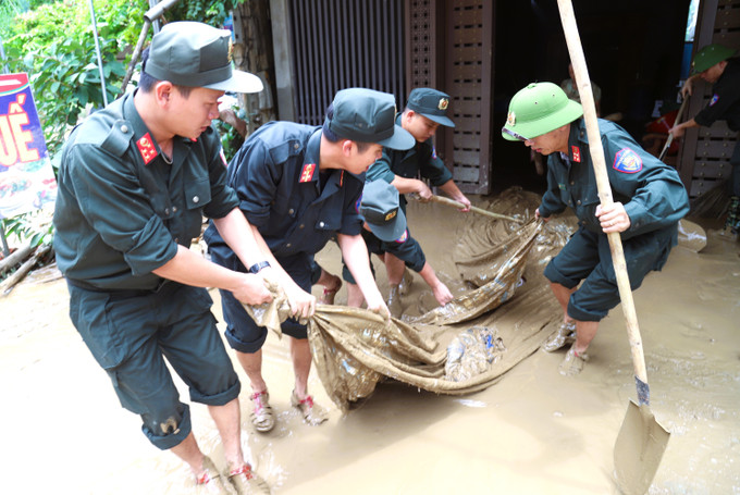 Lực lượng vũ trang, quân đội tham gia giúp dân khắc phục hậu quả lũ lụt. Ảnh: Xuân Tiến/TTXVN con-cuong-25725-12.jpg