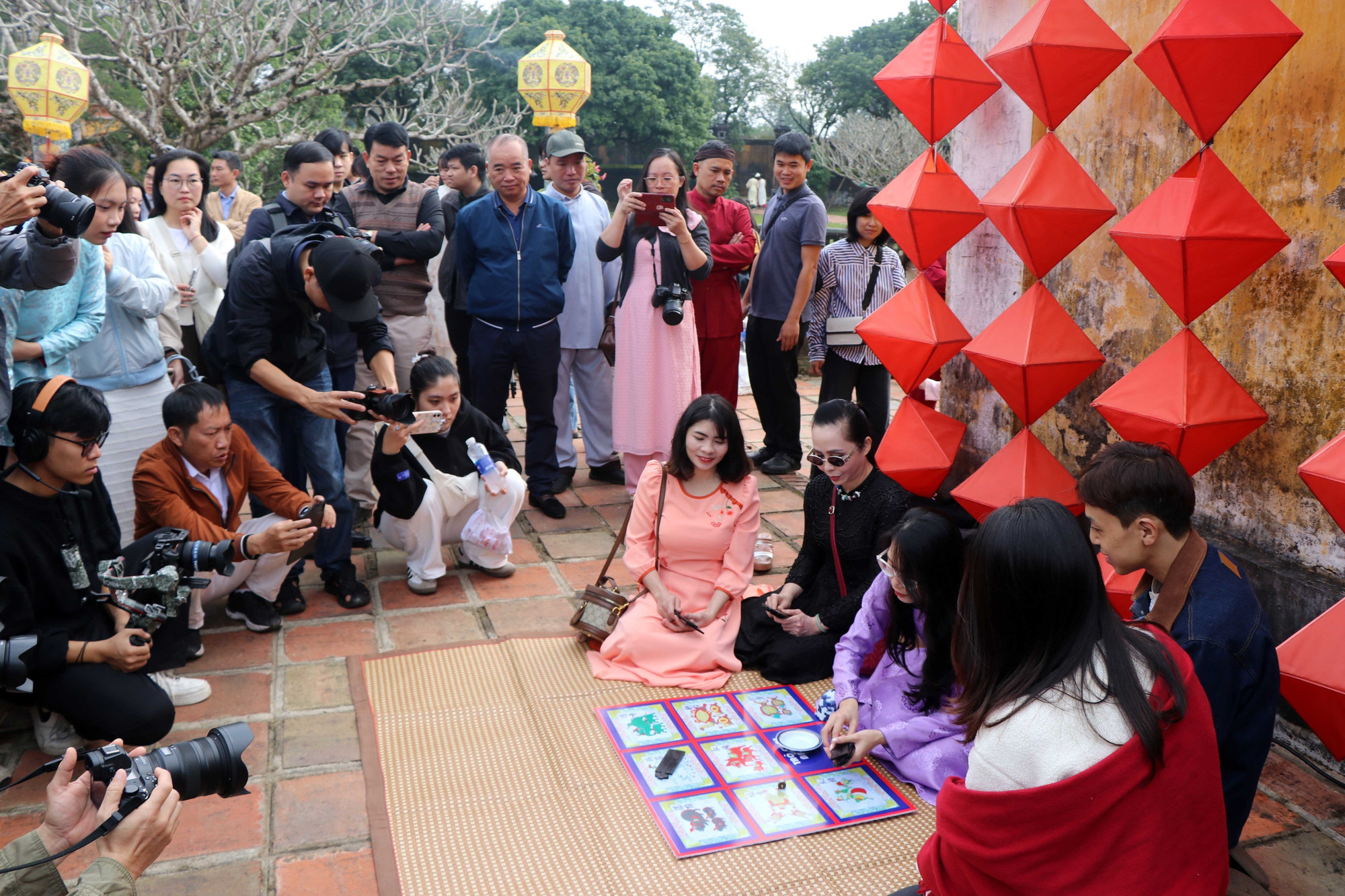 Du khách thích thú tham gia trò chơi truyền thống ngày Tết ở Cung Trường Sanh trong Đại Nội Huế. Ảnh: Đỗ Trưởng - TTXVN potal-net-dep-phong-vi-tet-o-hoang-cung-hue-7821606.jpg