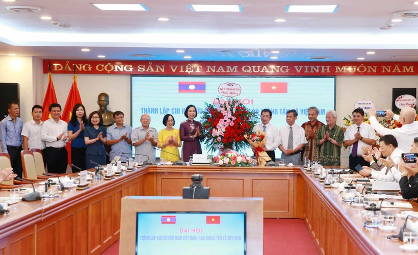 Đồng chí Vũ Việt Trang, Tổng giám đốc Thông tấn xã Việt Nam tặng hoa chúc mừng Ban Chấp hành Chi hội Hữu nghị Việt Nam - Lào Thông tấn xã Việt Nam. Ảnh: Phương Hoa - TTXVN