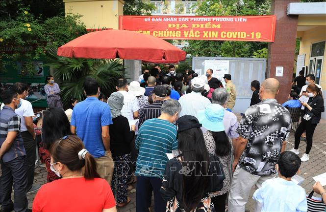 14h chiều 6/11, tại điểm tiêm phòng COVID-19 phường Kim Liên, quận Đống Đa, người dân chen chúc đến xếp hàng tiêm phòng không đảm bảo giữ khoảng cách. Ảnh: Thành Đạt - TTXVN