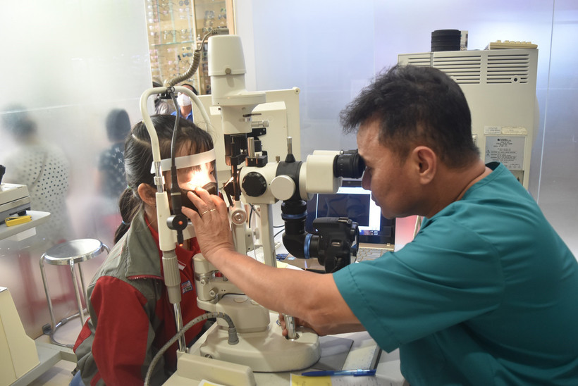 Bác sĩ Chuyên khoa II Ngô Văn Cường, Trưởng Khoa Mắt, Bệnh viện Đa khoa vùng Tây Nguyên thăm, khám cho bệnh nhi bị đau mắt đỏ. Ảnh: Nguyên Dung – TTXVN