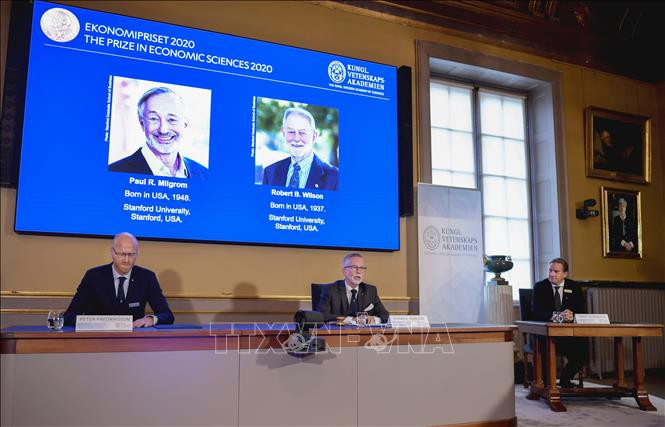 Chân dung hai nhà kinh tế người Mỹ (trên màn hình) Paul. R.Milgrom (trái) và Robert B.Winson đoạt giải Nobel Kinh tế 2020 trong cuộc họp báo công bố giải Nobel ở Stockholm, Thụy Điển ngày 12/10/2020. Ảnh: AFP/TTXVN