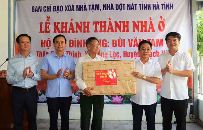 Ông Trần Thế Dũng, Phó Bí thư tỉnh ủy Hà Tĩnh trao quà cho hộ được nhận nhà mới ở huyện Thạch Hà. Ảnh: Công Tường/TTXVN Ông Trần Thế Dũng, Phó Bí thư tỉnh ủy Hà Tĩnh trao quà cho hộ được nhận nhà mới ở huyện Thạch Hà. Ảnh: Công Tường/TTXVN