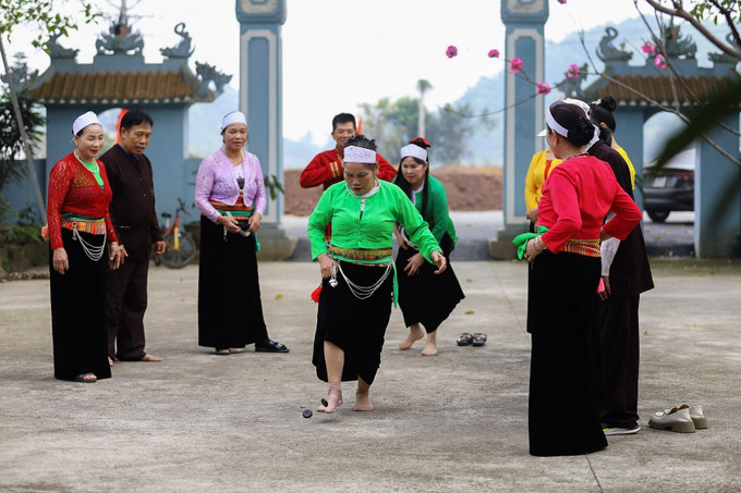 Các mế mường và đàn ông Mường chơi trò chơi đáng mảng của người Mường.