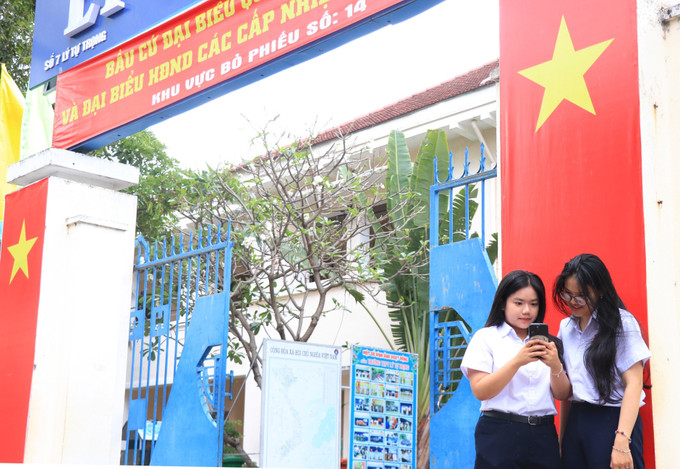 Những cử tri tròn đủ trong 18 tuổi Trường THPT Lý Tự Trọng tìm hiều về Ngày hội bầu cử 15/3. Ảnh: Phan Sáu/TTXVN