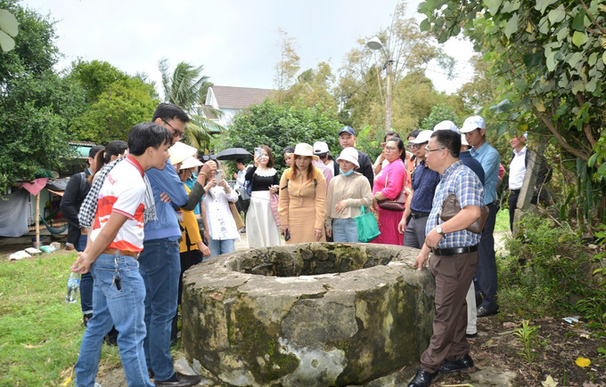 Du khách tham quan giếng cổ tại Làng Gò Cỏ, phường Phổ Thạnh, thị xã Đức Phổ (Quảng Ngãi). Ảnh: Đinh Hương/TTXVN