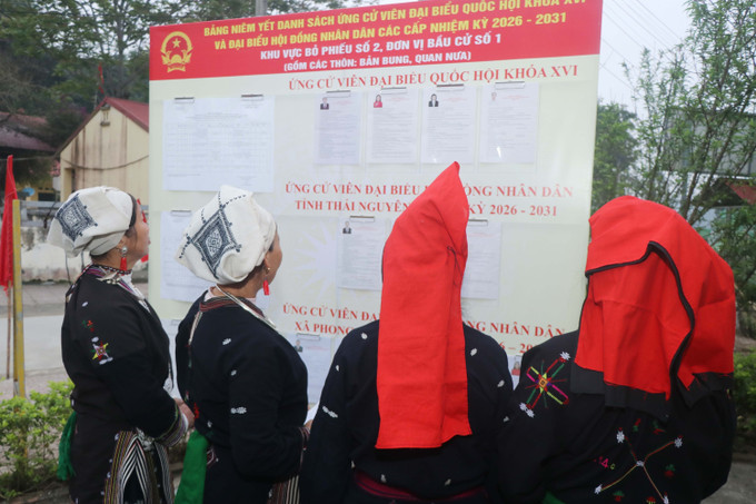 Người dân thôn Bản Bung tập trung xem danh sách người ứng cử. Ảnh: Vũ Hoàng Giang/TTXVN