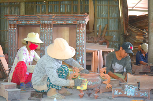 Sản xuất chiếc tủ thờ Gò Công phải trải qua 6 công đoạn: Cưa, tiện, mộc, cẩn, sơn, ráp thành. Mỗi thợ chỉ đảm nhận một công đoạn. Ngoài sản xuất tủ thờ, các thợ còn làm thêm các sản phẩm truyền thống khác của người Việt Nam. Ảnh: nld.com.vn Độc đáo làng nghề tủ thờ Gò Công trên 100 năm tuổi ảnh 2