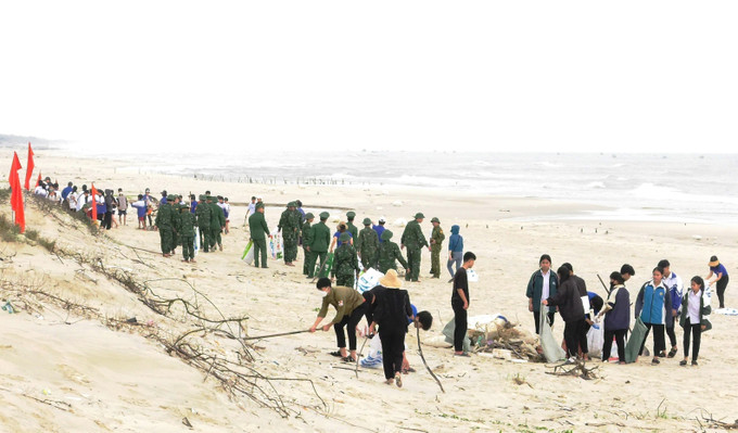 Đông đảo người dân, đoàn viên thanh niên địa phương và Bộ đội Biên phòng Quảng Bình tham gia thu gom rác thải, làm sạch bờ biển Tân Hải, xã Ngư Thủy Bắc, huyện Lệ Thủy. Ảnh: TTXVN phát Nhiều hoạt động tình nguyện hướng về khu vực biên giới ảnh 1