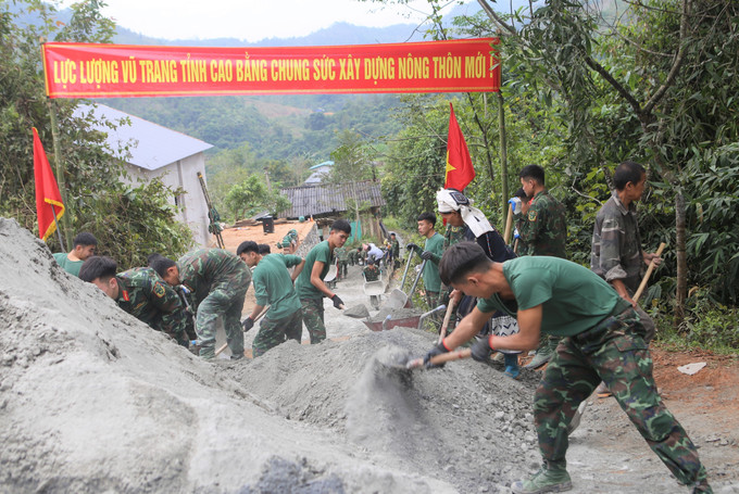 Cán bộ, chiến sĩ Trung đoàn 852 (Bộ Chỉ huy Quân sự tỉnh Cao Bằng) giúp dân bê-tông hóa tuyến đường giao thông nông thôn. Ảnh: Chu Hiệu-TTXVN Cao Bằng: Lan tỏa, phát huy phẩm chất Bộ đội Cụ Hồ ảnh 1