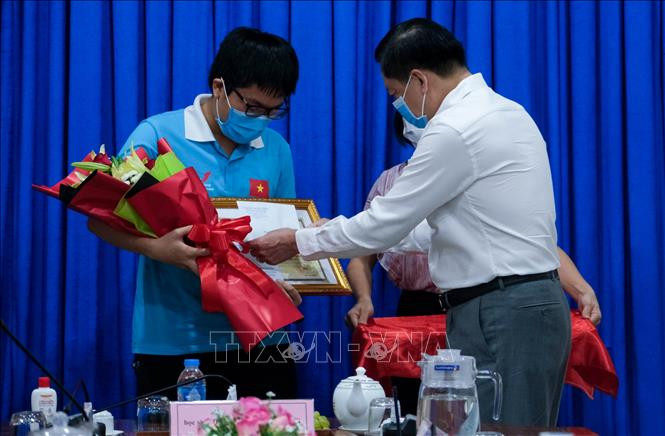 Ông Dương Tấn Hiển, Phó Chủ tịch UBND thành phố kiêm Giám đốc Sở GD&ĐT Cần Thơ tặng bằng khen cho em Đặng Lê Minh Khang tối 24/7. Ảnh: Thu Hiền – TTXVN Chàng trai "vàng" giỏi môn Sinh học ở Cần Thơ ảnh 1