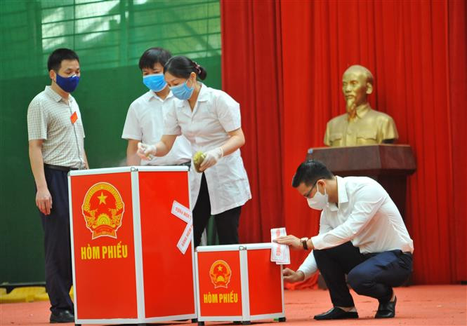 Lực lượng chức năng niêm phong hòm phiếu tại đơn vị bầu cử số 7, Khu cách ly trong Trường Đại học Thể dục Thể thao, phường Trang Hạ, thị xã Từ Sơn. Ảnh: Minh Đức - TTXVN Ngày bầu cử đặc biệt tại Bắc Ninh ảnh 2