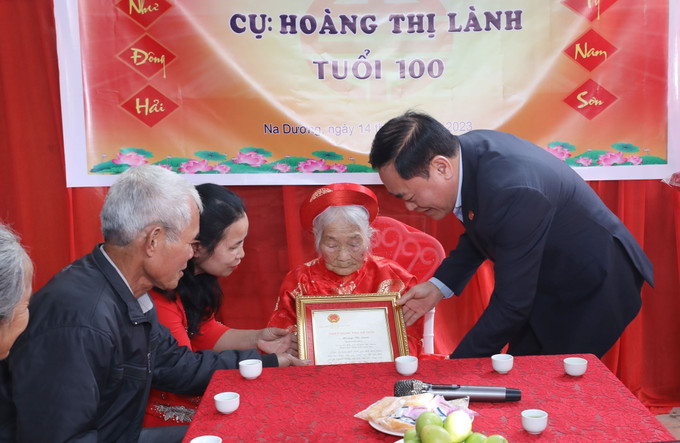 Chủ tịch UBND tỉnh Lạng Sơn Hồ Tiến Thiệu trao Thiếp mừng thọ 100 tuổi của Chủ tịch nước cho cụ Hoàng Thị Lành, khu 5A, thị trấn Na Dương, huyện Lộc Bình. Ảnh: Anh Tuấn – TTXVN Ngày quốc tế người cao tuổi 1/10: Chăm lo đời sống tinh thần cho người cao tuổi là mục tiêu lâu dài ảnh 3
