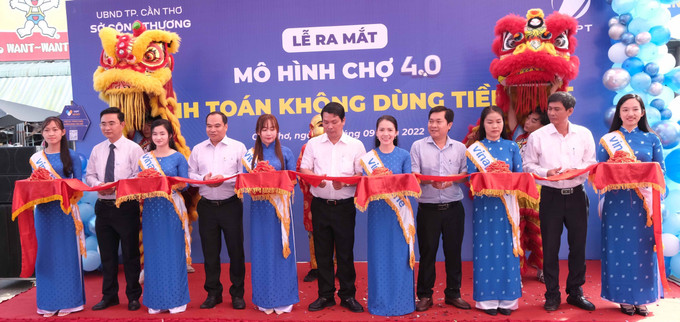 Các đại biểu cắt băng ra mắt mô hình Chợ 4.0 – Thanh toán không dùng tiền mặt đầu tiên ở Cần Thơ. Ảnh: Thanh Liêm – TTXVN Cần Thơ có chợ đầu tiên thanh toán không dùng tiền mặt ảnh 3