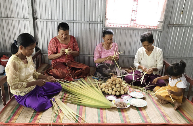 Bà Neáng Phương (thứ 2, từ phải qua trái) hướng dẫn các mẹ, các chị ở xã Ô Lâm, huyện Tri Tôn (An Giang) cách gói bánh cũng như cách trộn các nguyên liệu chuẩn bị gói bánh Kà Tum. Ảnh: Công Mạo Về Bảy Núi ăn bánh Kà Tum ảnh 3