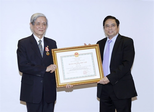 Đồng chí Phạm Minh Chính, Ủy viên Bộ Chính trị, Bí thư Trung ương Đảng, Trưởng Ban tổ chức Trung ương trao tặng Huân chương Độc lập hạng Nhất cho đồng chí Hồ Tiến Nghị. Ảnh: An Đăng - TTXVN