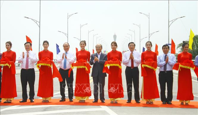 Thủ tướng Nguyễn Xuân Phúc cùng lãnh đạo Trung ương và địa phương thực hiện nghi thức cắt băng thông xe cầu Cửa Hội. Ảnh: Tá Chuyên - TTXVN