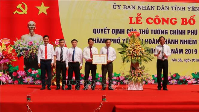 Thừa ủy quyền của Thủ tướng Chính phủ, ông Nguyễn Văn Khánh, Phó chủ tịch UBND tỉnh Yên Bái trao Quyết định công nhận thành phố Yên Bái hoàn thành nhiệm vụ xây dựng nông thôn mới năm 2019. Ảnh: Tuấn Anh -TTXVN 