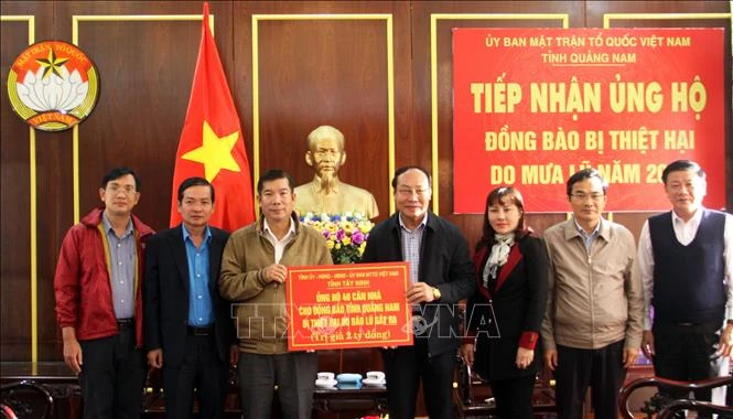Ông Võ Xuân Ca - Chủ tịch Ủy ban Mặt trận Tổ quốc Việt Nam tỉnh Quảng Nam tiếp nhận quà hỗ trợ đồng bào bị thiệt hại do Đoàn công tác tỉnh Tây Ninh tặng. Ảnh: Trịnh Bang Nhiệm - TTXVN