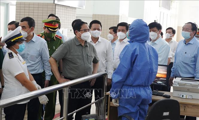Thủ tướng Phạm Minh Chính thăm hỏi, động viên các đơn vị làm nhiệm vụ tại Trạm liên hợp cửa khẩu quốc tế Mộc Bài. Ảnh: Lê Đức Hoảnh - TTXVN 