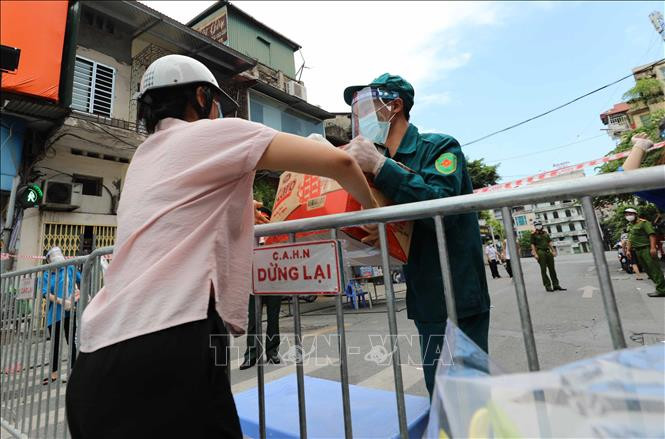 Nhu yếu phẩm được gửi vào cho người thân đang sống trong khu vực phường Văn Miếu, quận Đống Đa bị phong tỏa. Ảnh: Thanh Tùng - TTXVN 