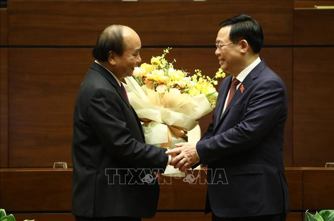 Chủ tịch Quốc hội Vương Đình Huệ chúc mừng đồng chí Nguyễn Xuân Phúc hoàn thành xuất sắc nhiệm vụ. Ảnh: Văn Điệp - TTXVN