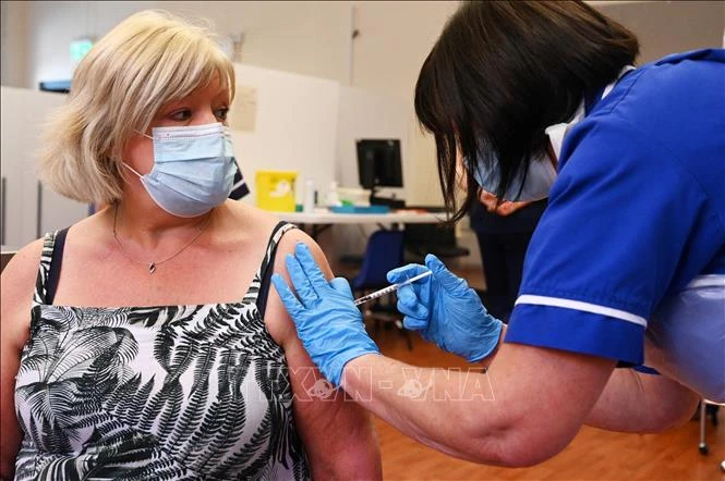 Nhân viên y tế tiêm vaccine phòng COVID-19 của hãng Pfizer/BioNTech cho người dân tại Derby, Anh, ngày 20/9/2021. Ảnh: AFP/ TTXVN 