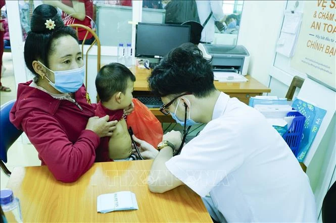 Bác sĩ khám sàng lọc bệnh tim cho trẻ. Ảnh: Xuân Tư – TTXVN