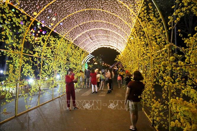 Du khách chụp ảnh tại đường hoa Phan Thiết. Ảnh: Nguyễn Thanh - TTXVN