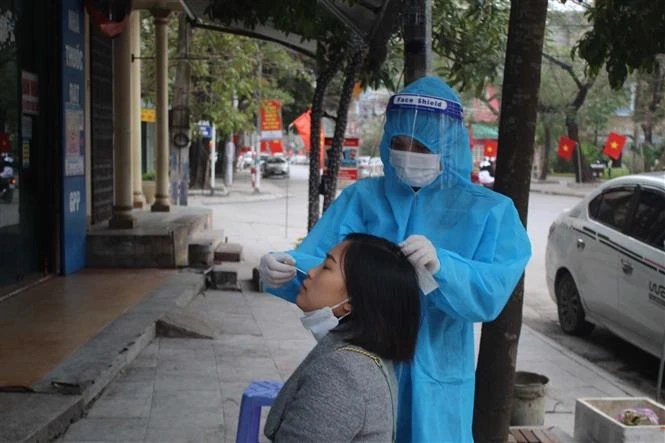 Nhân viên y tế lấy mẫu xét nghiệm COVID-19 cho người dân thành phố Thanh Hóa trong ngày mùng 5 tết Nguyên đán 2022. Ảnh: Nguyễn Nam-TTXVN 