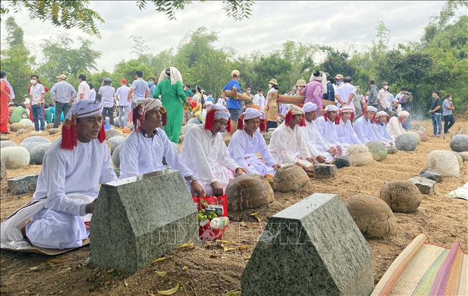 Bà con đồng bào Chăm theo đạo làm lễ tảo mộ nhân dịp Tết Ramưvan. Ảnh: Công Thử - TTXVN 