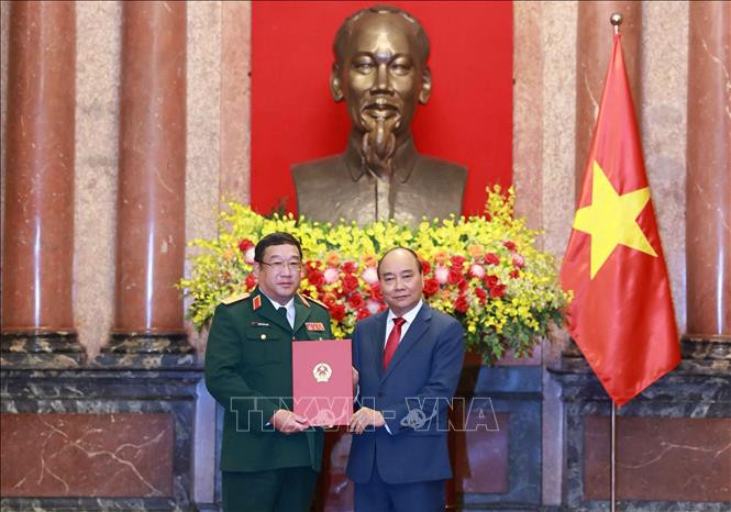Chủ tịch nước Nguyễn Xuân Phúc trao quyết định thăng quân hàm trước niên hạn từ Phó đô đốc lên cấp Thượng tướng cho đồng chí Phạm Hoài Nam. Ảnh:qdnd.vn 