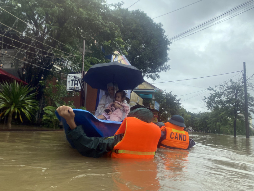 Lực lượng chức năng đưa người dân ở khu vực bị ngập sâu đến nơi an toàn. Ảnh: TTXVN phát 