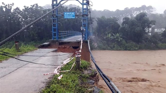Cầu treo bắc qua sông Pô kô, đoạn nối thị trấn Đăk Glei và thôn Đông Sông, thôn Đông Thượng (huyện Đăk Glei, tỉnh Kon Tum) đã bị nước lũ cuốn trôi mố Cầu. Ảnh: TTXVN phát 