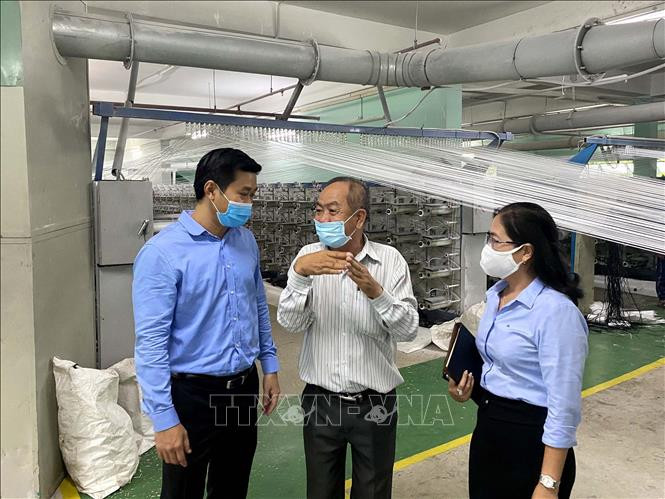 Ông Hứa Quốc Hưng, Trưởng Ban Quản lý các Khu chế xuất, Khu công nghiệp Thành phố Hồ Chí Minh cùng đoàn đại biểu với lãnh đạo Công ty trách nhiệm hữu hạn In và sản xuất bao bì Đức Mỹ, ở khu công nghiệp Hiệp Phước. Ảnh: Thanh Vũ - TTXVN Thành phố Hồ Chí Minh kiểm tra toàn diện công tác phòng, chống dịch COVID-19 tại các doanh nghiệp ảnh 1