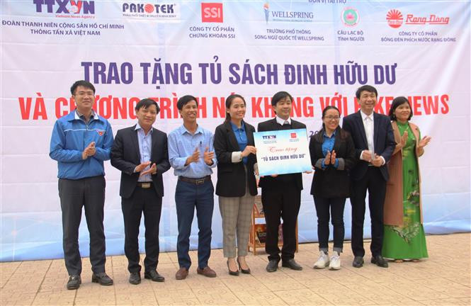Trao tặng biểu trưng "Tủ sách Đinh Hữu Dư" cho trường THCS Trần Kim Xuyến. Ảnh: Hoàng Ngà - TTXVN Đoàn Thanh niên TTXVN trao tặng Tủ sách Đinh Hữu Dư tại Hà Tĩnh ảnh 1