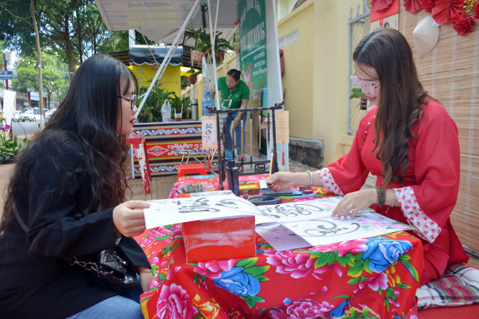 Gian hàng thư pháp tại Chợ phiên @ Buôn Ma Thuột. Ảnh: Hoài Thu - TTXVN Chợ phiên @ Buôn Ma Thuột thu hút du khách ảnh 4