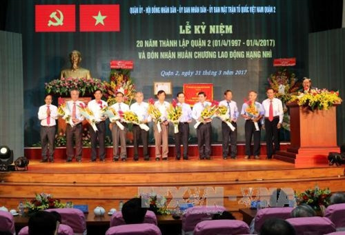 Lãnh đạo Quận 2 tặng hoa cho các đồng chí nguyên là lãnh đạo qua các thời kỳ. Ảnh: Thanh Vũ - TTXVN