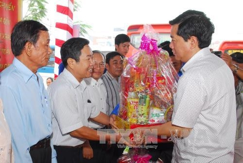 Bí thư Thành ủy Đinh La Thăng tặng quà cho các gia đình chính sách quận Bình Tân tại Bến xe Miền Tây. Ảnh: Mạnh Linh-TTXVN