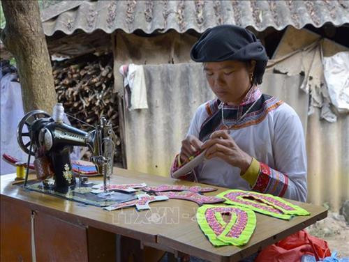 Chị Hoàng Lao Tú người dân tộc Xạ Phang đang thêu những đôi giày. Ảnh: Văn Dũng - TTXVN Chị Hoàng Lao Tú người dân tộc Xạ Phang đang thêu những đôi giày. Ảnh: Văn Dũng - TTXVN