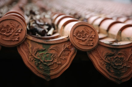 Ngôi nhà cổ được xây từ năm 1799 - Ảnh : Ngọc Tiến. Ngôi nhà được chúa Nguyễn Ánh cho xây dựng vào năm 1799 theo lối kiến trúc truyền thống của Việt Nam với ba gian, hai chái làm nơi trú ngụ cho Giám mục Bá Đa Lộc (quốc tịch Pháp, sinh năm 1741), người dạy học cho hoàng tử Nguyễn Cảnh lúc đó. Ban đầu ngôi nhà được xây dựng bên phần đất của Thảo Cầm Viên bây giờ. Năm 1911, khi Tòa Tổng Giám mục hiện nay được xây dựng hoàn thành, ngôi nhà dời về đây và được giữ gìn, bảo quản đến ngày hôm nay - Ảnh : Ngọc Tiến. Qua những lần di dời trước đó, phần nền đất làm cho cột trụ ngôi nhà bị hư hỏng. Sau đợt trùng tu nền nhà được nâng cao hơn, cột trụ ngôi nhà được đặt trên những tảng đá để đỡ một phần tải trọng và chắc chắn hơn như nguyên bản ngôi nhà ban đầu - Ảnh : Ngọc Tiến. Dàn rui lách, kèo và hệ thống vách được xếp đặt một cách tinh xảo - đó là nét độc đáo và giá trị to lớn về lịch sử và văn hóa ngôi nhà - Ảnh : Ngọc Tiến. Mái nhà được lợp ngói âm dương với những họa tiết hoa văn viền tinh xảo. Hiện nay, lớp ngói đỏ đã được làm mới thay cho lớp ngói cũ rêu phong - Ảnh : Ngọc Tiến. Các cánh cửa làm bằng gỗ quý, hoa văn được điêu khắc tinh xảo tạo thêm nét cổ kính cho mặt tiền của căn nhà - Ảnh : Ngọc Tiến. Ngôi nhà được làm hoàn toàn bằng gỗ quý, khung nhà được liên kết chặt chẽ với nhau hoàn toàn bằng kỹ thuật ghép mộng của những nghệ nhân thời xưa. Hoàn toàn không dùng bất cứ cây đinh nào nhưng ngôi nhà vẫn đứng vững qua hàng trăm năm - Ảnh : Ngọc Tiến. Các nét chạm khắc trên những bộ cửa, vách nhà chưa bị bào mòn và còn nguyên vẹn - Ảnh : Ngọc Tiến. Họa tiết trang trí được khắc họa tỉ mỉ, công phu đặt ngay cửa chính diện tạo sự cân đối và cổ kính, thể hiện nét sáng tạo độc đáo - Ảnh : Ngọc Tiến. Nhiều vật dụng trong nhà như bàn, ghế, tủ, bình phong... vẫn được giữ nguyên vẹn và còn khá tốt. Những chùm đèn được thay mới vì đèn cũ đã hư hỏng, không thể sử dụng được nữa - Ảnh : Ngọc Tiến.