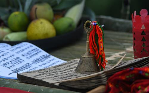 Bàn thờ treo bộ tranh thờ “Tam thanh” - 3 vị thần trong tín ngưỡng người Dao cai quản 3 nơi là Ngọc thanh (thần cai quản trên trời), Thượng thanh (thần cai quản trần gian) và Thái thanh (thần cai quản âm phủ). Theo truyền thuyết, tuy là vua nhưng Bàn Vương vẫn giữ thói quen sống giản dị, gần gũi với thiên nhiên. Ngài luôn căn dặn các con phải chăm chỉ lao động sản xuất. Có một lần, Bàn Vương cùng tùy tùng lên núi săn bắn, đuổi theo một con sơn dương bị thương, chẳng may bị sơn dương húc, ngài ngã vào cây gù hương và mất tại đó. Thi thể Bàn Vương bị vướng trên nhành cây, các con bèn chặt cây làm thân trống, đuổi bắt con sơn dương để lấy da làm trống tế lễ Bàn Vương. Từ đó. cứ đến khoảng tháng 2 Âm lịch hàng năm, con cháu người Dao từ đời này sang đời khác phải nhớ ngày cúng giỗ Bàn Vương, thể hiện sự biết ơn với tổ tiên đã sinh ra họ. Người dân các thôn chuẩn bị lễ vật, chờ đến giờ tốt để dâng lên Bàn Vương. Các thầy cúng bắt đầu thay lễ phục, giúp nhau sửa soạn mũ áo. Chân dung một trong số sáu thầy cúng của buổi lễ. Ông Triệu Chòi Quyên, thầy cúng trong xã, cho biết: "Các thầy cúng sẽ hát những bài ca cúng để nhờ thần linh, thổ địa nghênh đón Bàn Vương xuống đàn, nhận lễ vật của con cháu dâng lên". Sau mỗi lời khấn bằng tiếng Dao, thầy cúng và người dân các thôn cùng quỳ lạy Bàn Vương. Các điệu múa chuông, múa bắt rùa... lần lượt được các thầy cúng thực hiện sau khi mời để tái hiện lại tiểu sử của Bàn Vương năm xưa như vóc dáng, cách hái lượm săn bắn. Việc này theo các thầy cúng vừa để thể hiện ý chí, sức mạnh sinh tồn của người xưa, vừa để nhắc nhở con cháu ngày nay cần cù, chịu khó làm ăn như cha ông trước đây. Theo ông Quyên, vật chày là một trò chơi dân gian thể hiện sức mạnh, sự kết hợp khéo léo, sự bí ẩn của cả người gánh và người vật. Sau khi thầy cúng làm phép nhờ thần linh giúp đỡ, dù rất đông người cùng tham gia nhưng không thể ấn nổi đầu chày chạm đất. Điều này thể hiện việc bản làng năm đó được các vị thần phù hộ, nâng đỡ. Người dân tới dâng lễ và tham gia lễ hội Bàn Vương. Bàn thờ treo bộ tranh thờ “Tam thanh” - 3 vị thần trong tín ngưỡng người Dao cai quản 3 nơi là Ngọc thanh (thần cai quản trên trời), Thượng thanh (thần cai quản trần gian) và Thái thanh (thần cai quản âm phủ). Theo truyền thuyết, tuy là vua nhưng Bàn Vương vẫn giữ thói quen sống giản dị, gần gũi với thiên nhiên. Ngài luôn căn dặn các con phải chăm chỉ lao động sản xuất. Có một lần, Bàn Vương cùng tùy tùng lên núi săn bắn, đuổi theo một con sơn dương bị thương, chẳng may bị sơn dương húc, ngài ngã vào cây gù hương và mất tại đó. Thi thể Bàn Vương bị vướng trên nhành cây, các con bèn chặt cây làm thân trống, đuổi bắt con sơn dương để lấy da làm trống tế lễ Bàn Vương. Từ đó. cứ đến khoảng tháng 2 Âm lịch hàng năm, con cháu người Dao từ đời này sang đời khác phải nhớ ngày cúng giỗ Bàn Vương, thể hiện sự biết ơn với tổ tiên đã sinh ra họ. Người dân các thôn chuẩn bị lễ vật, chờ đến giờ tốt để dâng lên Bàn Vương. Các thầy cúng bắt đầu thay lễ phục, giúp nhau sửa soạn mũ áo. Chân dung một trong số sáu thầy cúng của buổi lễ. Ông Triệu Chòi Quyên, thầy cúng trong xã, cho biết: "Các thầy cúng sẽ hát những bài ca cúng để nhờ thần linh, thổ địa nghênh đón Bàn Vương xuống đàn, nhận lễ vật của con cháu dâng lên". Sau mỗi lời khấn bằng tiếng Dao, thầy cúng và người dân các thôn cùng quỳ lạy Bàn Vương. Các điệu múa chuông, múa bắt rùa... lần lượt được các thầy cúng thực hiện sau khi mời để tái hiện lại tiểu sử của Bàn Vương năm xưa như vóc dáng, cách hái lượm săn bắn. Việc này theo các thầy cúng vừa để thể hiện ý chí, sức mạnh sinh tồn của người xưa, vừa để nhắc nhở con cháu ngày nay cần cù, chịu khó làm ăn như cha ông trước đây. Theo ông Quyên, vật chày là một trò chơi dân gian thể hiện sức mạnh, sự kết hợp khéo léo, sự bí ẩn của cả người gánh và người vật. Sau khi thầy cúng làm phép nhờ thần linh giúp đỡ, dù rất đông người cùng tham gia nhưng không thể ấn nổi đầu chày chạm đất. Điều này thể hiện việc bản làng năm đó được các vị thần phù hộ, nâng đỡ. Người dân tới dâng lễ và tham gia lễ hội Bàn Vương.