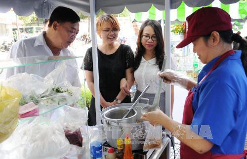 Khách tham quan, mua sắm tại phố ẩm thực hàng rong. Ảnh: An Hiếu - TTXVN