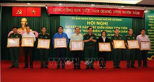 Đại tá Tô Danh Út, Chỉ huy trưởng Bộ đội Biên phòng Thành phố Hồ Chí Minh trao tặng Bằng khen của Chủ tịch UBND Thành phố cho đại diện tập thể đạt thành tích xuất sắc trong thực hiện "Ngày Biên phòng toàn dân" giai đoạn 2009-2019. Ảnh: Xuân Khu-TTXVN