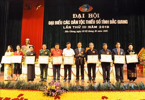 Ông Phan Văn Hùng - Thứ trưởng, Phó Chủ nhiệm Uỷ ban Dân tộc Bằng khen cho các cá nhân, tập thể có thành tích trong công tác dân tộc. Ảnh: Tùng Lâm – TTXVN.