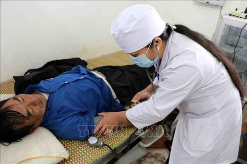 Bác sỹ tại Đơn nguyên điều trị nội trú Dào San đo huyết áp cho bệnh nhân. Ảnh: Công Tuyên - TTXVN
