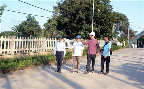 Đảng viên Nguyễn Tăng Đậu (thứ 2 bên phải), thôn 11, phường Đội Cấn, thành phố Tuyên Quang đã hỗ trợ toàn bộ chi phí máy móc và một phần vật liệu để làm đường bê tông liên thôn. Ảnh: Quang Cường – TTXVN