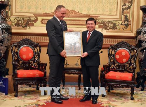 Ông Nguyễn Thành Phong, Chủ tịch UBND Thành phố Hồ Chí Minh (bên phải) tặng quà lưu niệm cho ông Juraj Droba, Chủ tịch Vùng Bratislava, Slovakia. Ảnh: Xuân Khu-TTXVN