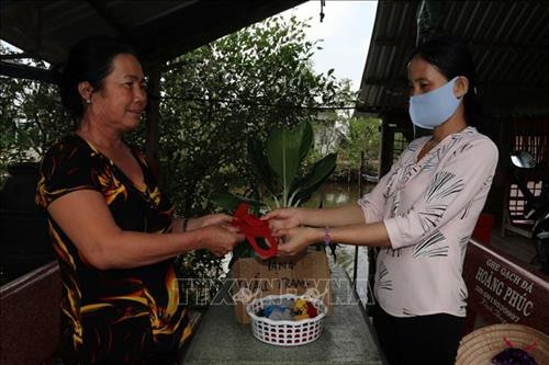 Bí thư Chi bộ, Trưởng ấp Trung Xinh Lê Thị Hoa tặng khẩu trang tự may cho người dân. Ảnh: Lê Sen – TTXVN Bí thư Chi bộ, Trưởng ấp Trung Xinh Lê Thị Hoa tặng khẩu trang tự may cho người dân. Ảnh: Lê Sen – TTXVN